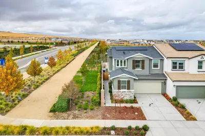 an aerial view of a house with a driveway at Newly Built Tracy Home with Backyard and Pool Access! in Tracy