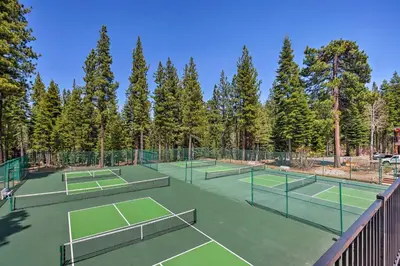 a group of tennis courts with trees in the background at Less Than 1 Mi to North Star Resort Condo with Balcony in Truckee