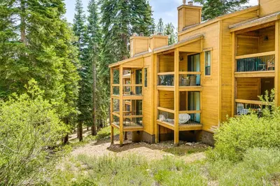 a wooden house in the woods with trees at Less Than 1 Mi to North Star Resort Condo with Balcony in Truckee