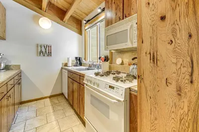 a kitchen with a white stove and a sink at Less Than 1 Mi to North Star Resort Condo with Balcony in Truckee