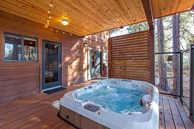 a jacuzzi tub on the deck of a house at Luxury 4 bedroom 4 5 bath luxury home that sleeps 10 in Incline Village