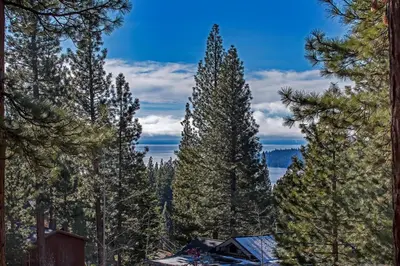 a view of a cabin in the woods with trees at Luxury 4 bedroom 4 5 bath luxury home that sleeps 10 in Incline Village