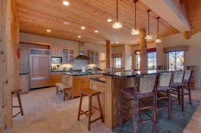 a kitchen with a large center island with bar stools at Sundance Lodge -Mountain Home w Views of Palisades - Ski Shuttle, Pets okay! in Olympic Valley