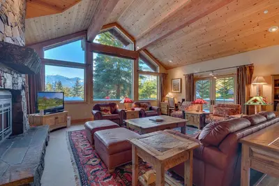 a living room with a couch and a fireplace at Sundance Lodge -Mountain Home w Views of Palisades - Ski Shuttle, Pets okay! in Olympic Valley