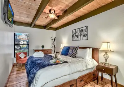 a bedroom with a bed and a television in it at Private beach, Close to ski, Resort Amenities! in South Lake Tahoe