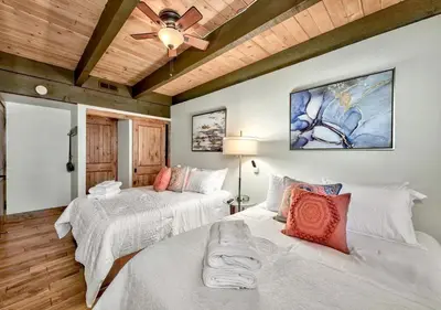 a bedroom with two beds and a ceiling fan at Private beach, Close to ski, Resort Amenities! in South Lake Tahoe