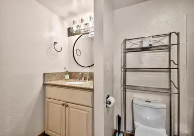 a bathroom with a sink and a toilet and a mirror at Private beach, Close to ski, Resort Amenities! in South Lake Tahoe