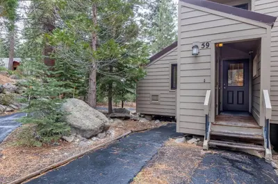 a small house with a blue door and a porch at Carnelian Woods # 59 - 2 BR Carnelian Bay Retreat - Minutes to Lake w HOA Amenities in Carnelian Bay