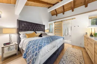 a bedroom with a large bed with a large headboard at Carnelian Woods # 59 - 2 BR Carnelian Bay Retreat - Minutes to Lake w HOA Amenities in Carnelian Bay