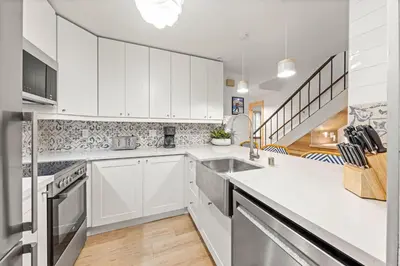 a kitchen with white cabinets and a sink at Carnelian Woods # 59 - 2 BR Carnelian Bay Retreat - Minutes to Lake w HOA Amenities in Carnelian Bay