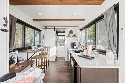 a kitchen and living room in a tiny house at Tiny Cargo Home South in Tulare