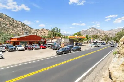 a street with cars parked on the side of a road at Tiny River House in Three Rivers