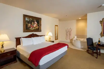 a hotel room with a bed and a bath tub at Silverland Inn in Virginia City