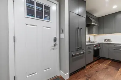 a kitchen with gray cabinets and a white door at Luxurious 2BD Smart Home Near Beach in Tahoe City
