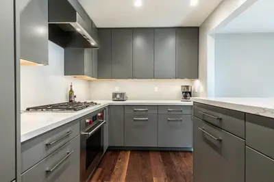 a kitchen with gray cabinets and a stove top oven at Luxurious 2BD Smart Home Near Beach in Tahoe City