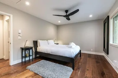 a bedroom with a bed with a ceiling fan at Luxurious 2BD Smart Home Near Beach in Tahoe City