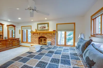 a bedroom with a large bed and a fireplace at 4 Mi to Slopes Family-Friendly Stateline Home! in Stateline