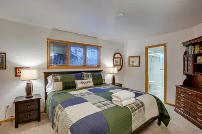 a bedroom with a bed and a dresser and a window at 4 Mi to Slopes Family-Friendly Stateline Home! in Stateline