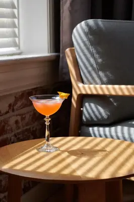 a martini glass sitting on a table next to a chair at The Jesse Hotel & Bar in Reno