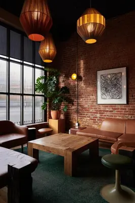 a room with a table and chairs and a brick wall at The Jesse Hotel & Bar in Reno