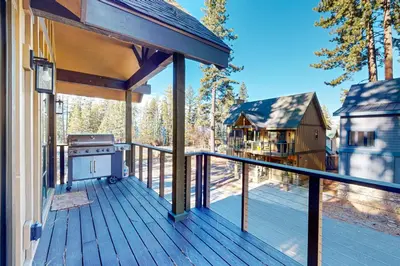 a deck with a grill and a house at Twilight's Rest in Zephyr Cove