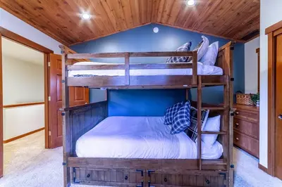 two bunk beds in a room with a blue wall at Luxury Townhome, Walk to the Village, Wifi, Private Spa & Garage in Mammoth Lakes
