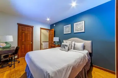 a blue bedroom with a large bed and a desk at Luxury Townhome, Walk to the Village, Wifi, Private Spa & Garage in Mammoth Lakes