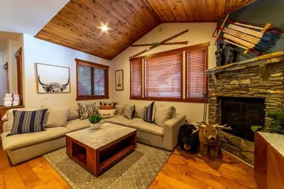 a living room with a couch and a fireplace at Luxury Townhome, Walk to the Village, Wifi, Private Spa & Garage in Mammoth Lakes