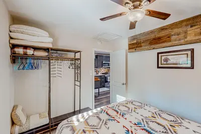 a bedroom with a bed and a ceiling fan at 1BR Dog-Friendly Lakefront Cabin with Canoes in Twain Harte
