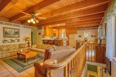 a living room with a couch and a table at A-Frame Cabin in The Sequoias in Wofford Heights