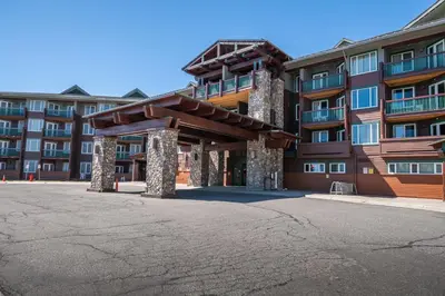 a large building with a parking lot in front of it at Juniper Springs Lodge #412 - Luxury Ski in Ski out! 2 Bedroom in Mammoth Lakes