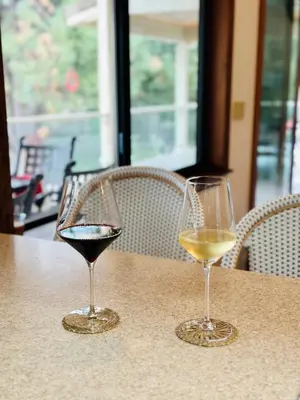 two glasses of wine sitting on a table at Luxury Yosemite Lake House in Groveland