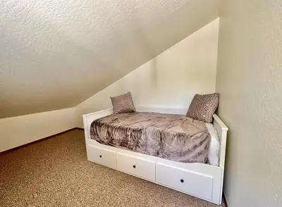 a bed in the corner of a room at Luxury Yosemite Lake House in Groveland