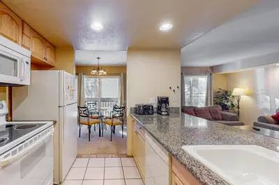 a kitchen with a counter and a table with chairs at Horizons 4 131 in Mammoth Lakes