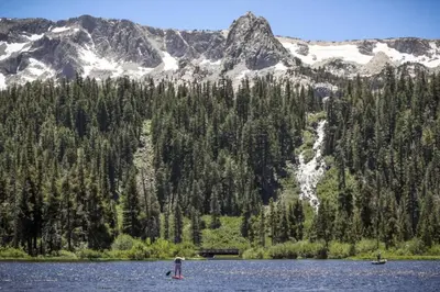 two people in a lake with mountains in the background at Horizons 4 131 in Mammoth Lakes