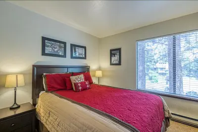 a bedroom with a bed and a large window at Horizons 4 138 in Mammoth Lakes