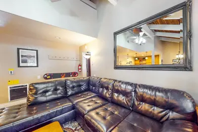 a leather couch in a living room with a mirror at Horizons 4 158 in Mammoth Lakes