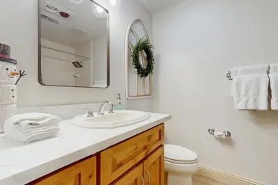 a bathroom with a sink and a toilet and a mirror at Gold Bear in Truckee