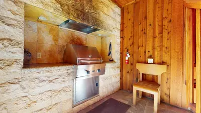 a kitchen with a stove and a wooden wall at Obsidian #1 home in Mammoth Lakes