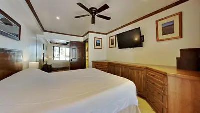 a bedroom with a bed and a flat screen tv at 1849 Condos 103 home in Mammoth Lakes