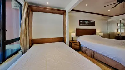 two beds in a room with a window at 1849 Condos 103 home in Mammoth Lakes