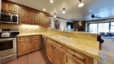 a kitchen with wooden cabinets and a sink at 1849 Condos 103 home in Mammoth Lakes