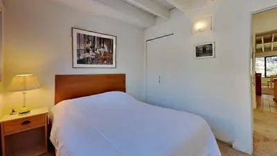 a white bedroom with a bed and a lamp and a window at 1849 Condos 631 home in Mammoth Lakes
