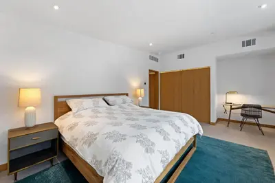 a bedroom with a large bed and a table at Stellar Ski-in Ski-out Out # 2 at Northstar 2 by Tahoe Getaways - Pet-Friendly 3BR Townhome w Loft, Shuttle and HOA! in Truckee-Tahoe Airport