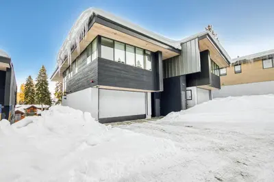 a house with a pile of snow in front of it at Stellar Ski-in Ski-out Out # 2 at Northstar 2 by Tahoe Getaways - Pet-Friendly 3BR Townhome w Loft, Shuttle and HOA! in Truckee-Tahoe Airport