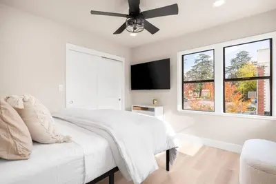 a white bedroom with a bed and a ceiling fan at Downtown Lodi l Renovated l 5 Bedrooms l Sleeps 10 in Lodi