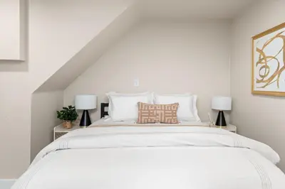 a bedroom with a large white bed with two lamps at Downtown Lodi l Renovated l 5 Bedrooms l Sleeps 10 in Lodi