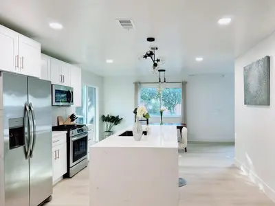 a kitchen with a white counter and a refrigerator at Trendy Trenholm in Elk Grove
