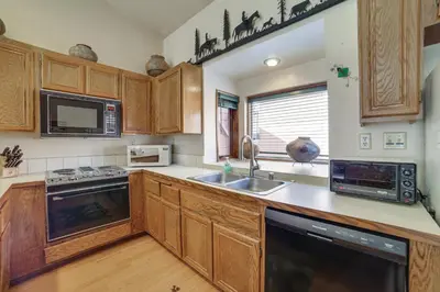 a kitchen with wooden cabinets and a sink at Mammoth Lakes Condo Walk to Village and Gondola! in Mammoth Lakes