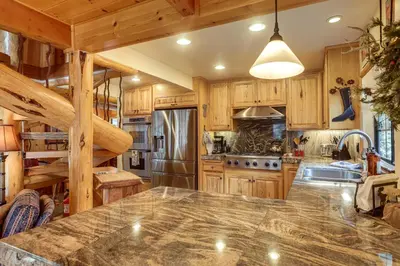 a kitchen with wooden cabinets and a large island at Less Than 1 Mi to Lake Tahoe Beaches Home with Fire Pit! in Tahoe City